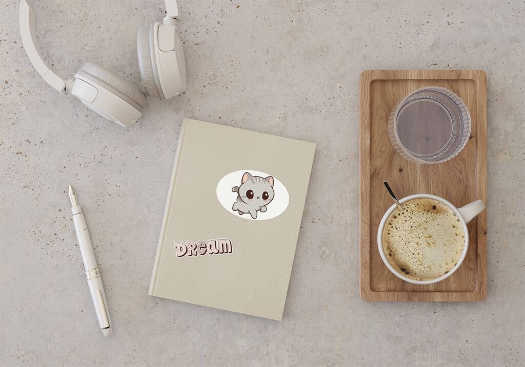 Cute kawaii kitten on personal notebook